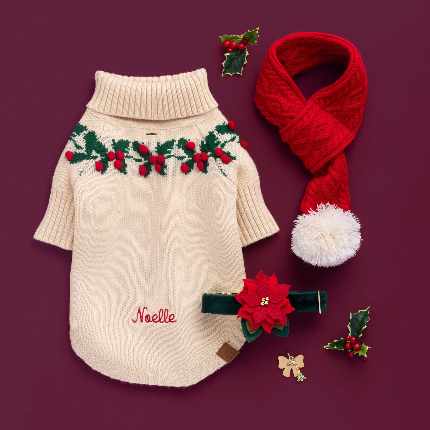 Holly Bobble Sweater, Red Cable Knit Dog Scarf, Poinsettia Collar Flower, Lady Bow ID Tag, and Christmas Charm from The Foggy Dog
