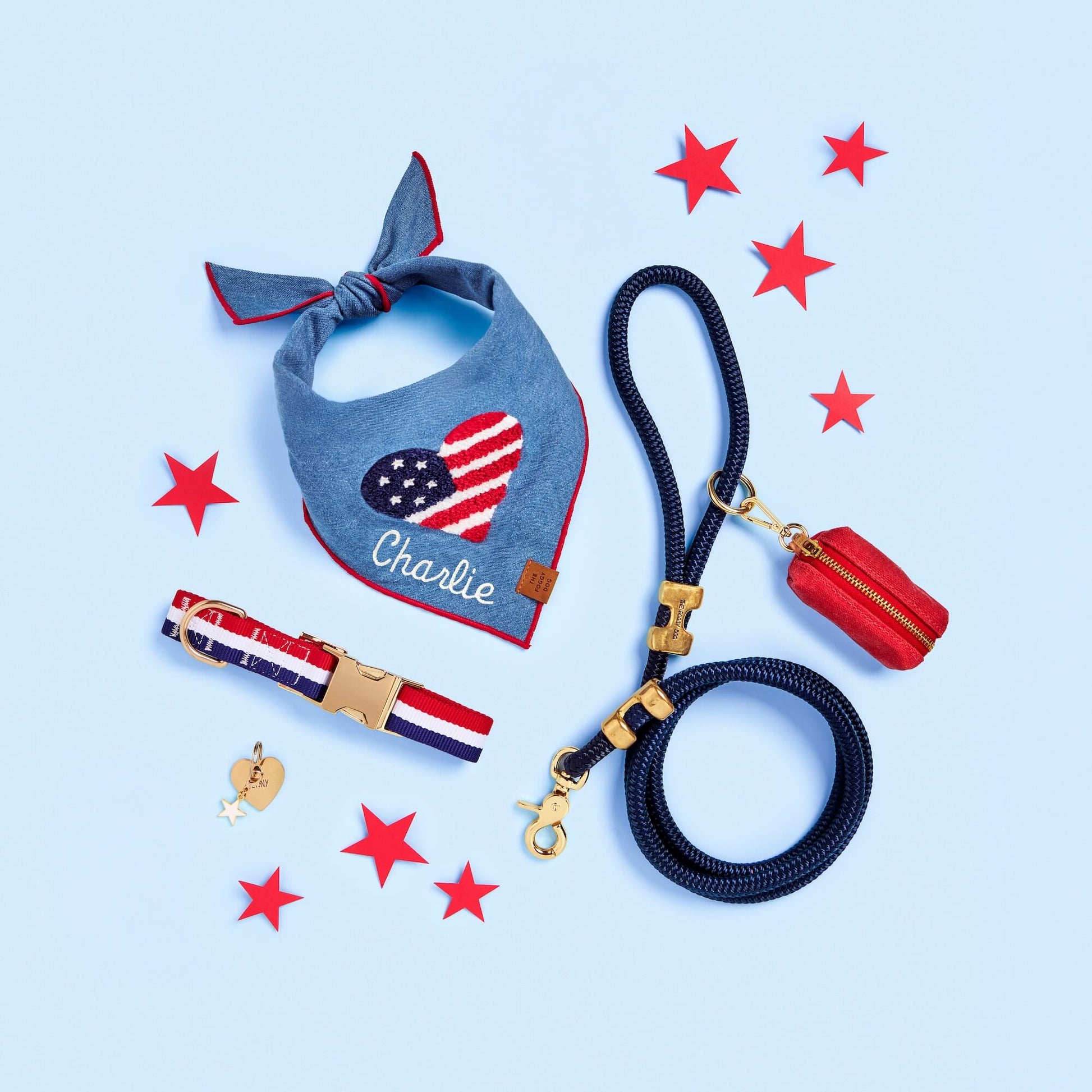 Americana Applique Dog Bandana, Newport Striped Webbing Dog Collar, White Star Collar Charm, Heart Pet ID Tag, Ocean Marine Rope Dog Leash, and Ruby Waxed Canvas Waste Bag Holder from The Foggy Dog