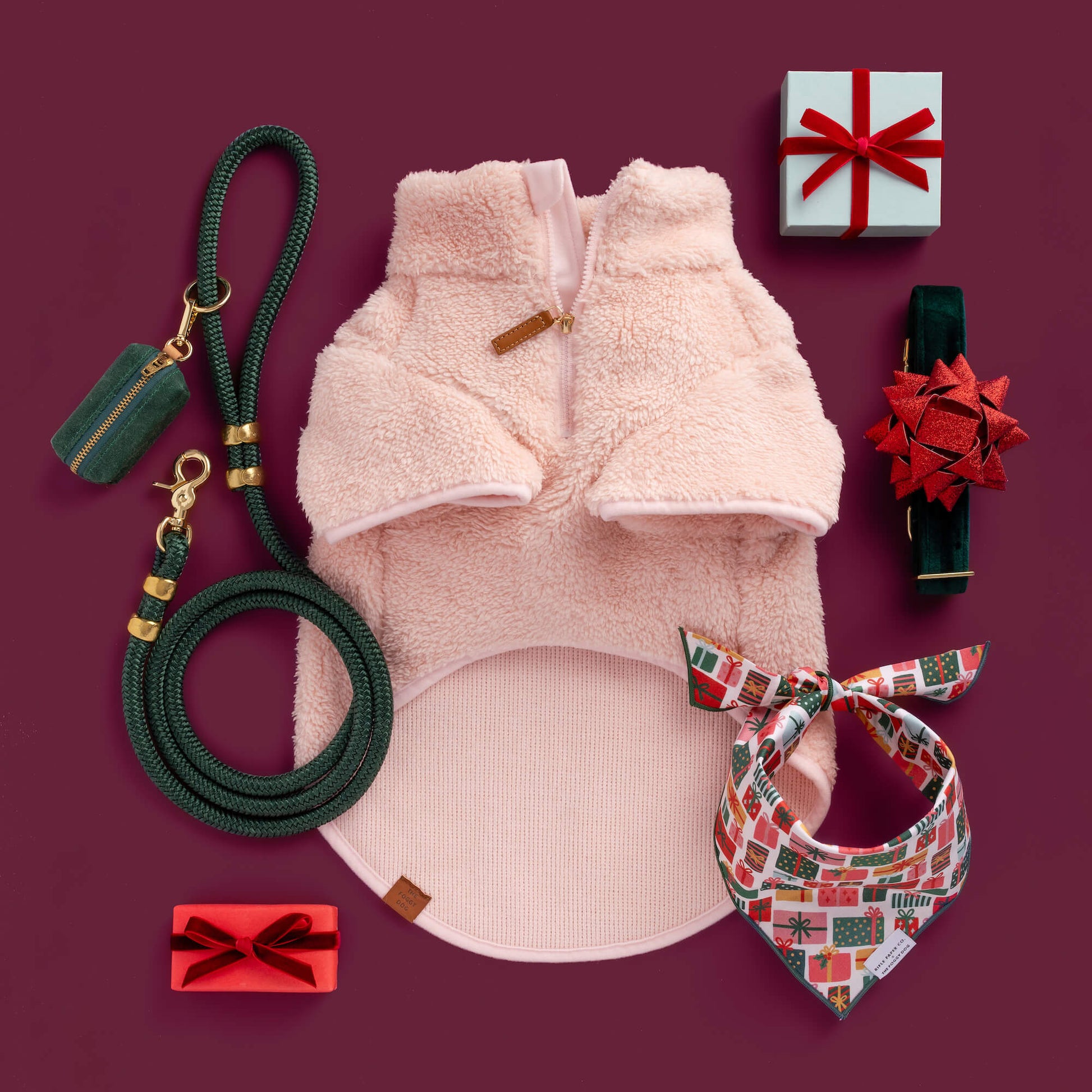 Pink Quarter-Zip Sherpa Dog Jacket, Red Gift Bow Collar Set, Evergreen Marine Rope Leash, Evergreen Waxed Waste Bag, and Rifle Paper Co. x TFD Holiday Gifts Bandana from The Foggy Dog