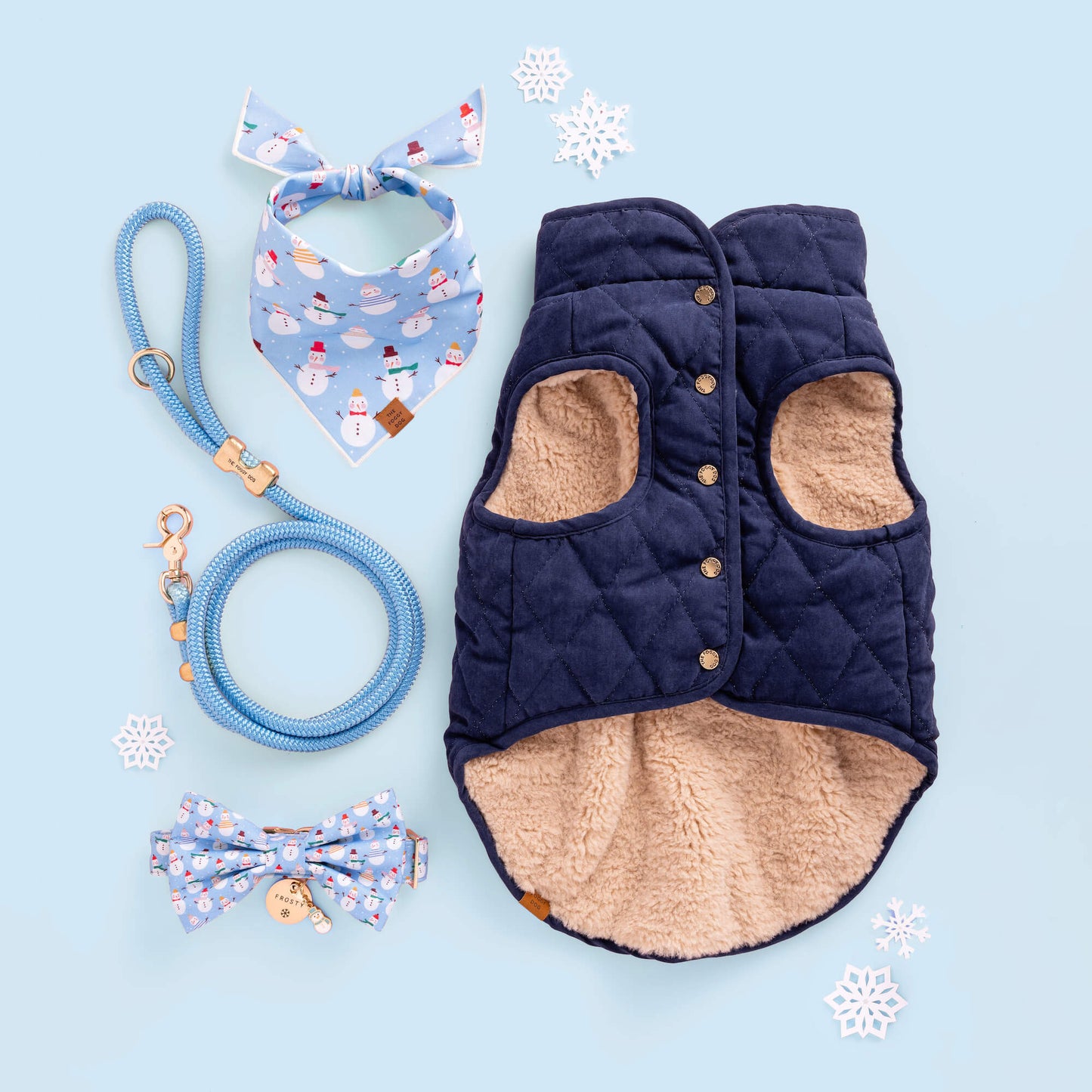 Frosty Friends Bow Tie Collar, Frosty Friends Bandana, Snowman Charm, Powder Blue Leash, Circle ID Tag with Snowflake Icon, Navy Sherpa Reversible Jacket from The Foggy Dog