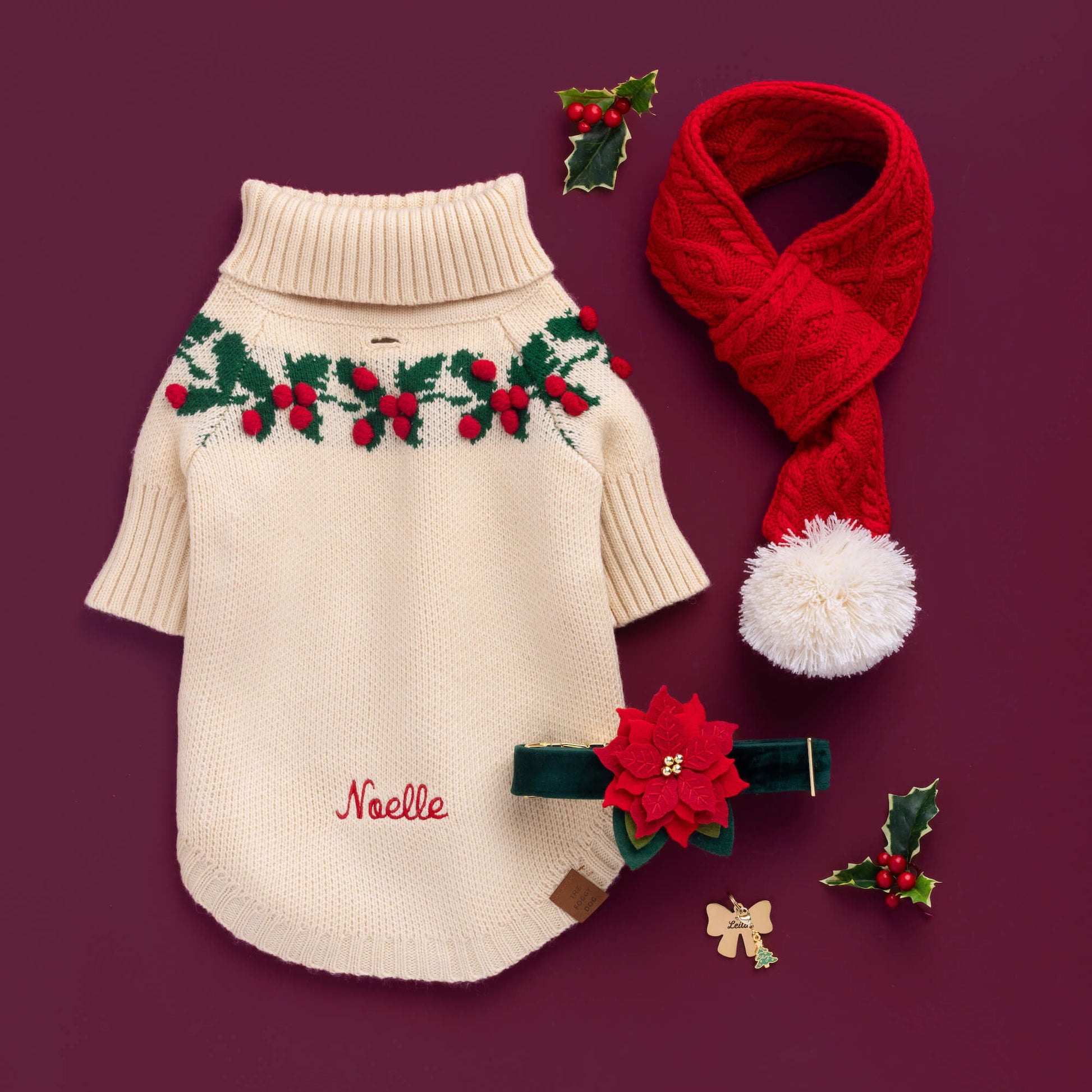 Holly Bobble Sweater, Red Cable Knit Dog Scarf, Poinsettia Collar Flower, Lady Bow ID Tag, and Christmas Charm from The Foggy Dog